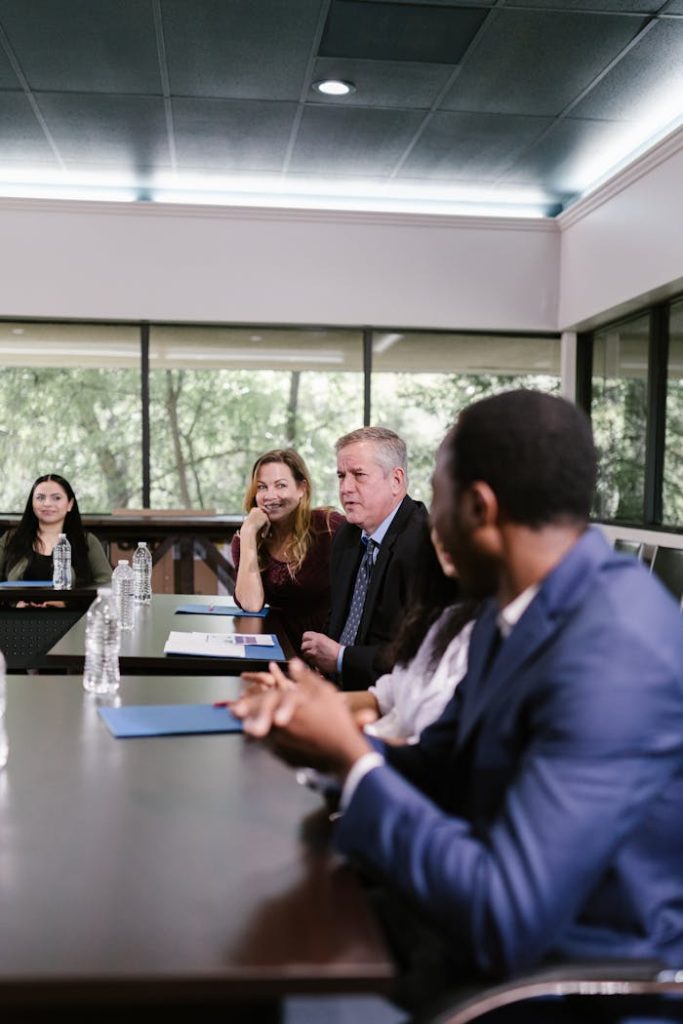 Corporate professionals engaged in an attentive meeting in a spacious conference room.